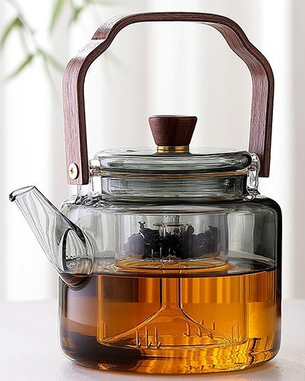 O bule cinza de vidro pode ser aquecido diretamente no forno de argila elétrica para cozinhar o bule com feixe de chá de flores